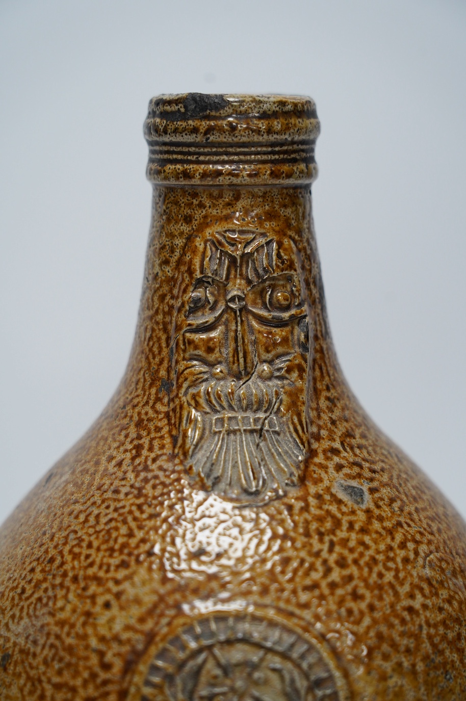 A 17th century Rhenish saltglazed Bellarmine, 23cm. Condition - commensurate with age